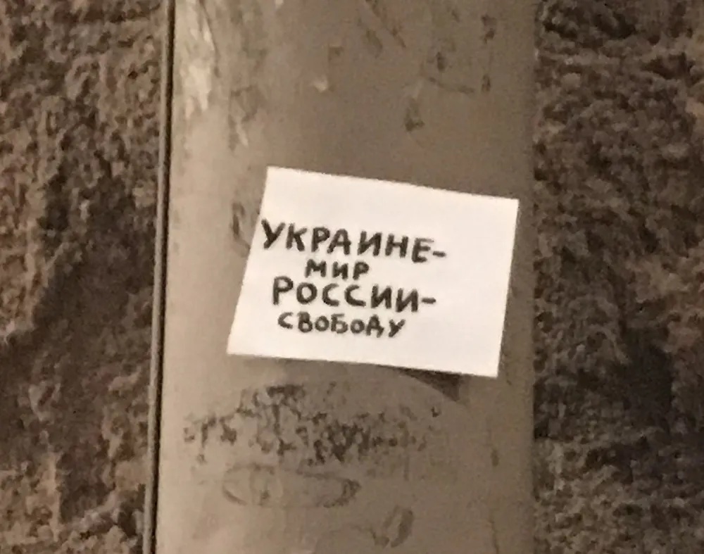 A small flyer affixed to a downspout in central Moscow reads “Peace to Ukraine Freedom to Russia.”